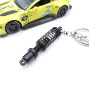 キーホルダー キーリング ショックアブソーバー ダンパー サスペンション 自動車 おしゃれ 記念品 プチギフト プレゼント 贈り物 ファッション小物 女性用 男性用 青 黒 緑 赤 金色 ゴールドカラー