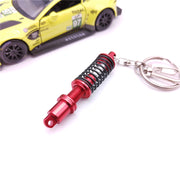 キーホルダー キーリング ショックアブソーバー ダンパー サスペンション 自動車 おしゃれ 記念品 プチギフト プレゼント 贈り物 ファッション小物 女性用 男性用 青 黒 緑 赤 金色 ゴールドカラー