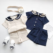 セットアップ 上下セット 半袖 シャツ ハーフパンツ 2点セット キッズ 子供服 男の子 女の子 男女兼用 ラウンドネック セーラーカラー風 ライン 前開き ボタン 半ズボン 短パン ウエストゴム ポケット付き マリン 単色 無地 シンプル 着回し かわいい おしゃれ カジュアル 定番 お出かけ 通園 通学 ユニセックス 青 ベージュ
