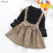 ドッキングワンピース キッズ 子供服 子ども服 女の子 フェイクツーピース フェイクレイヤード 重ね着風 ハイネック 長袖 Aライン ミニスカート ミニ丈 フレアスカート リボン 袖フリル ジャンパースカート風 総柄 チェック ブラック ピンク イエロー ガーリー 可愛い キュート カジュアル ライトフォーマル